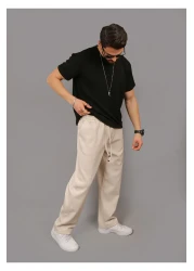 INFLUYENTE بنطال رياضي رجالي بيج فضفاض من قماش بيكيه بخصر مطاطي وجيب مفصل