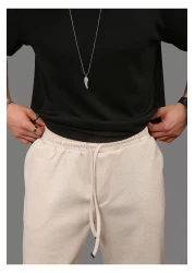 INFLUYENTE بنطال رياضي رجالي بيج فضفاض من قماش بيكيه بخصر مطاطي وجيب مفصل